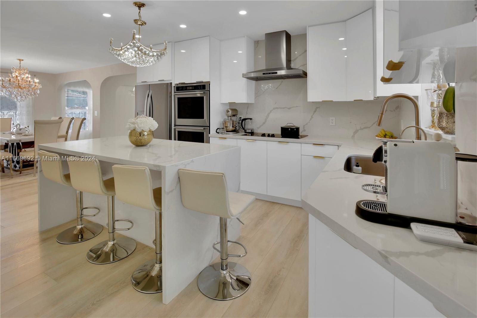 a kitchen with stainless steel appliances granite countertop a sink and a white cabinets