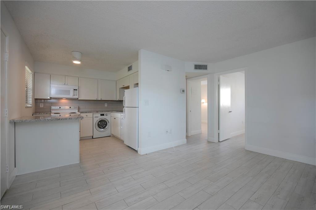 a kitchen with stainless steel appliances refrigerator sink and cabinets