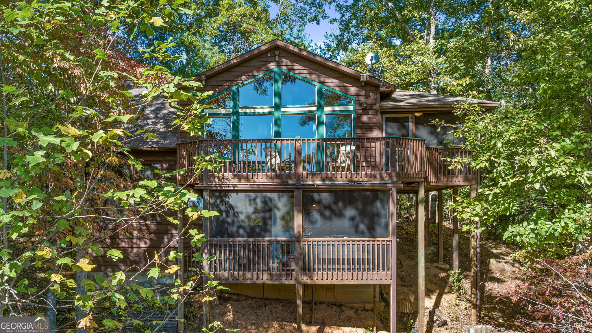 a small house with a tree in the background