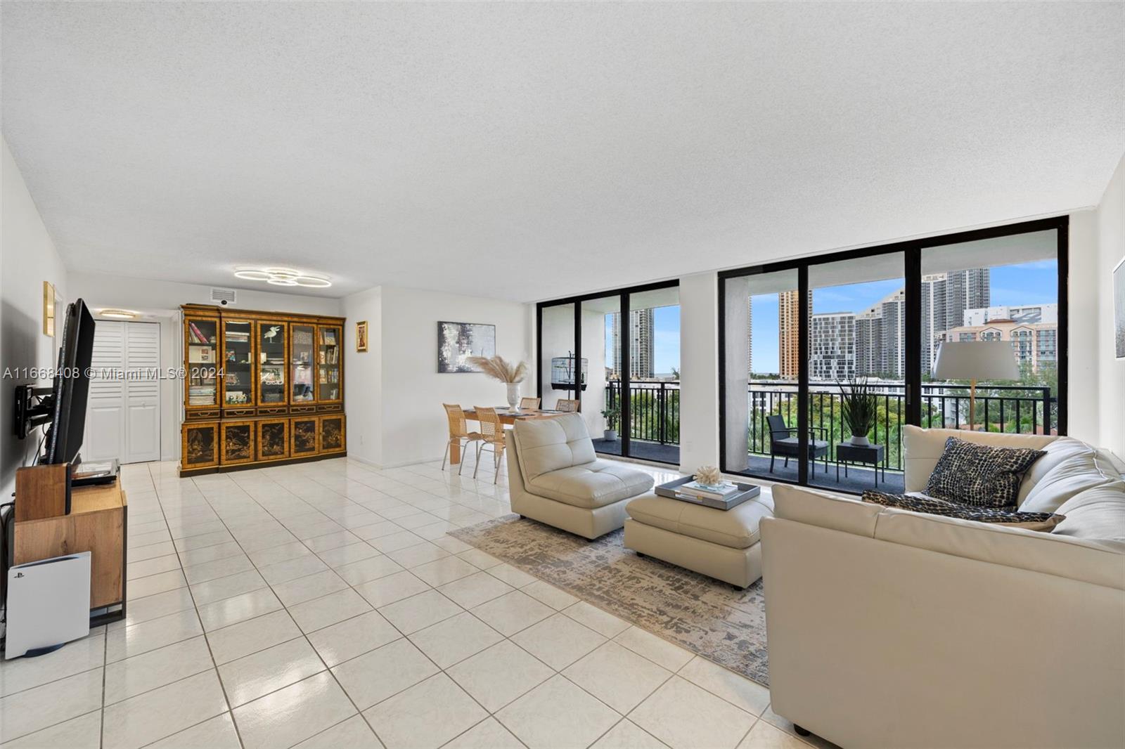 a living room with furniture and large windows