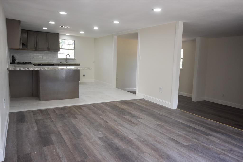 a kitchen with granite countertop a sink and a stove top oven