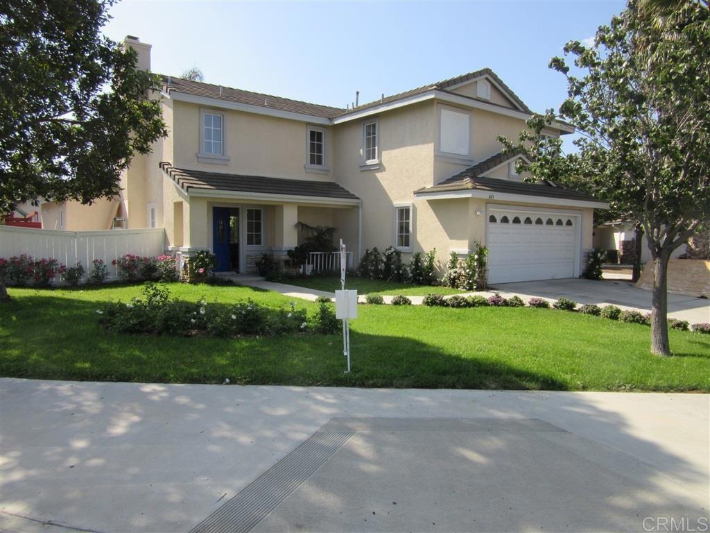 a front view of house with yard and green space