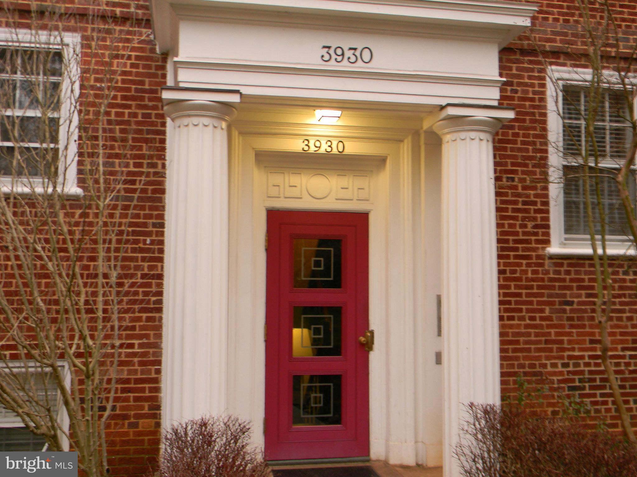 a view of a door with brick walls