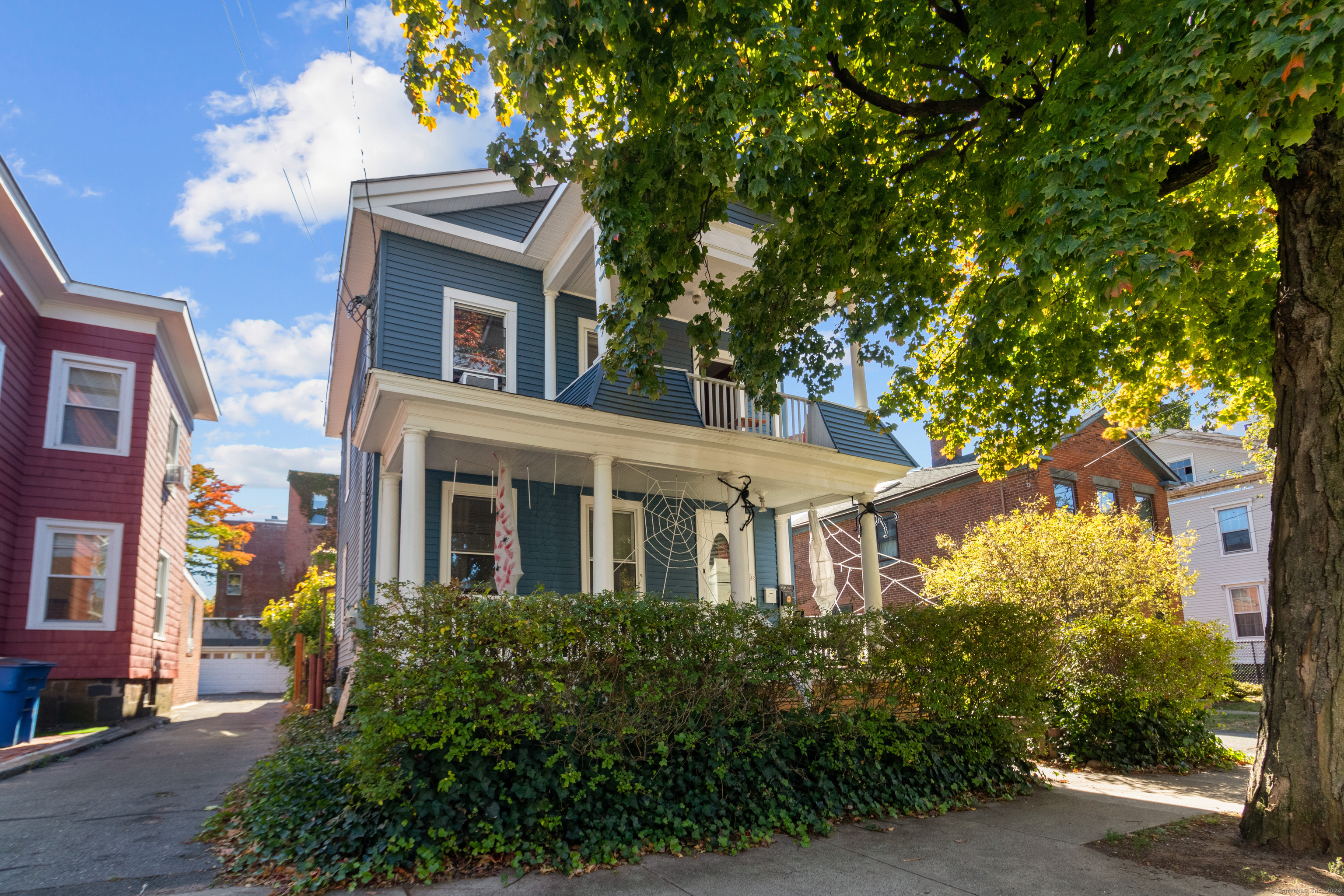 a front view of a residential houses with yard and green space