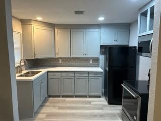 a kitchen with a sink and a refrigerator