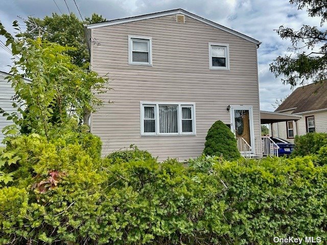 a view of a house with a small yard and plants