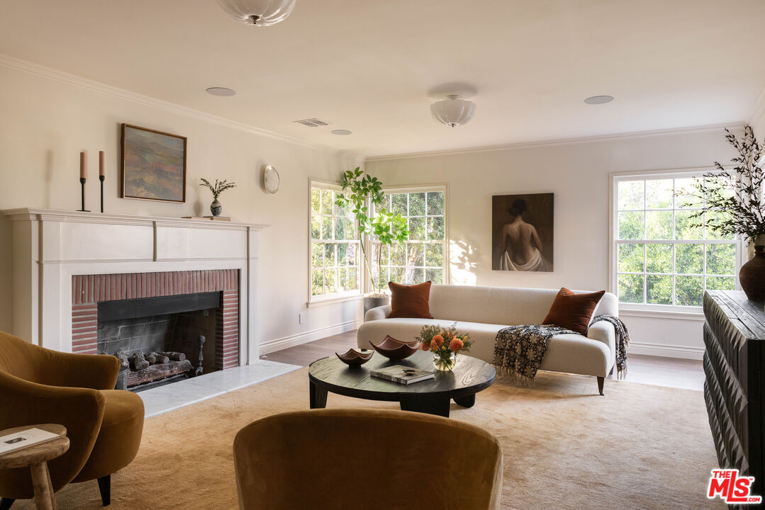 a living room with furniture fireplace and window