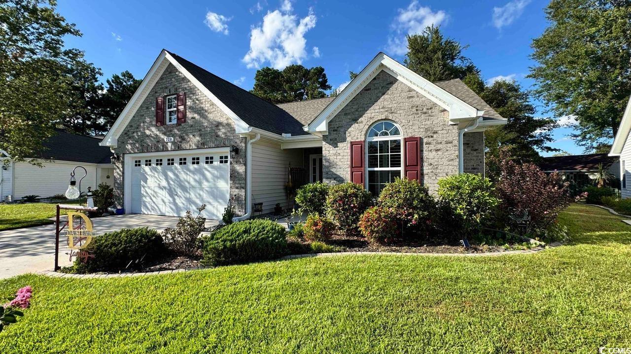 View of front of house featuring a garage and a ma