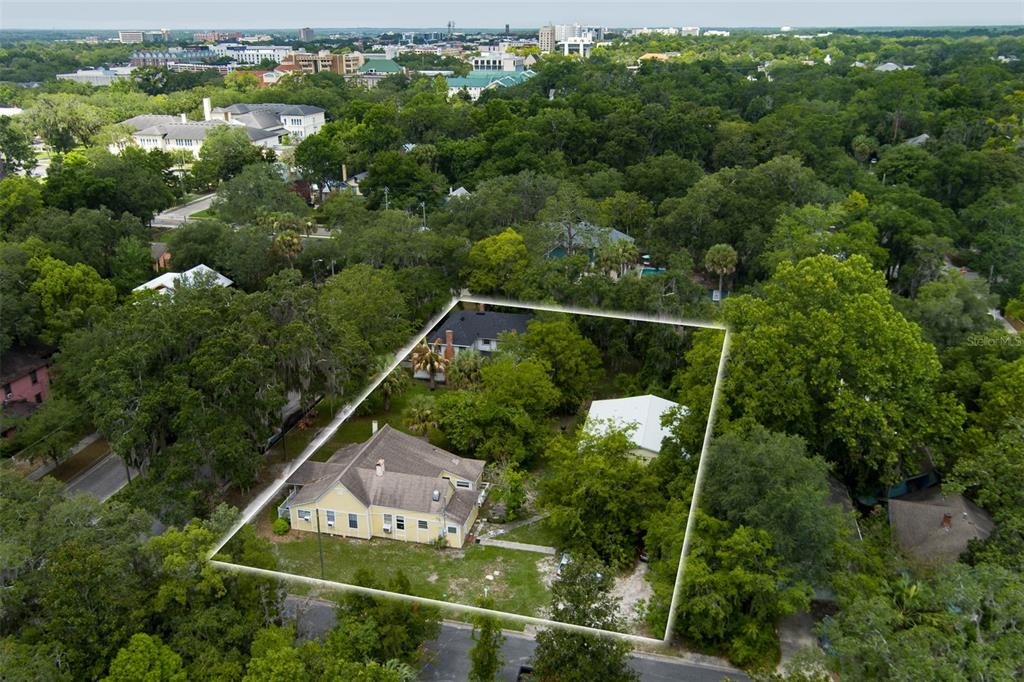 an aerial view of houses with a yard