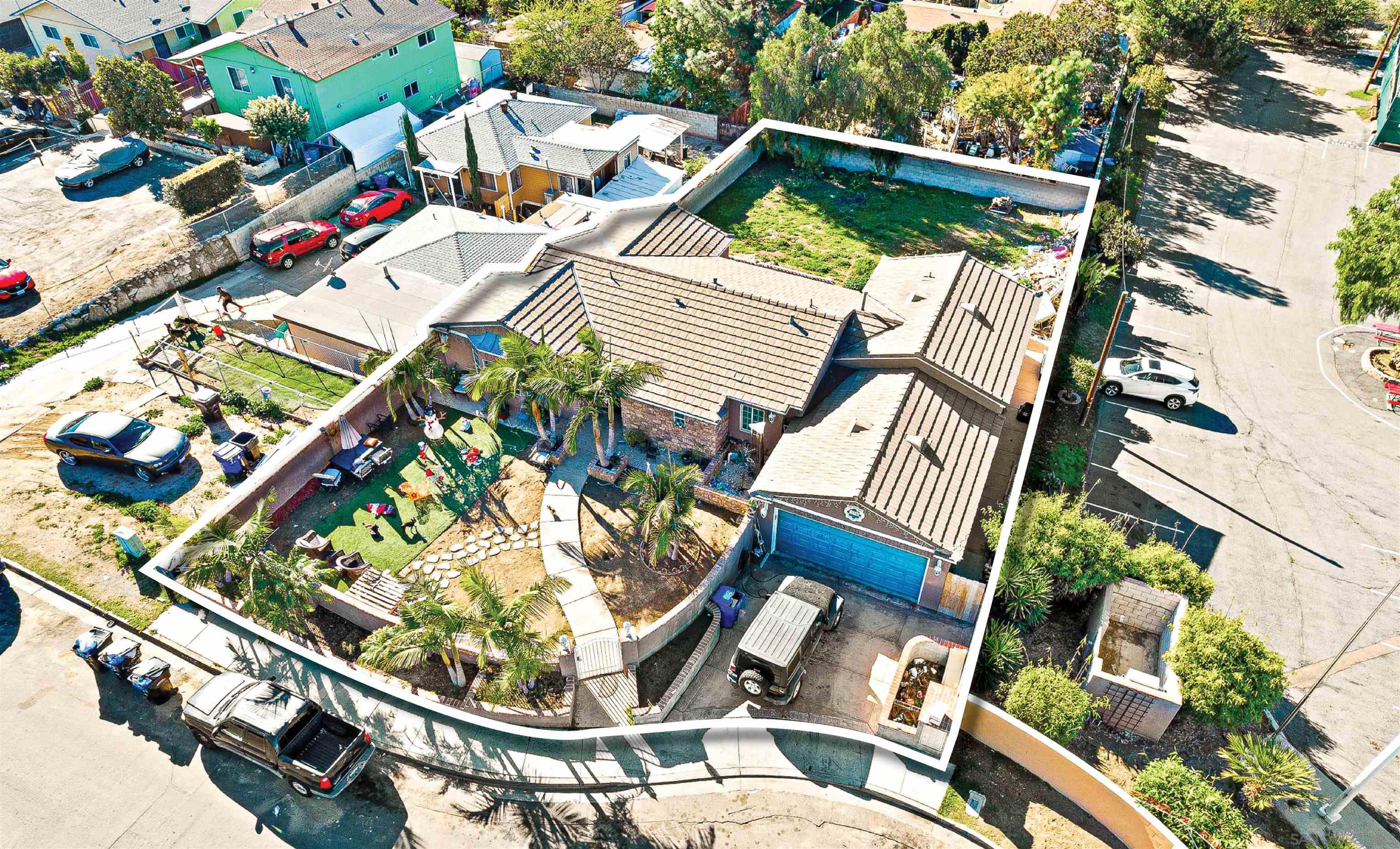 an aerial view of a house with a yard and balcony