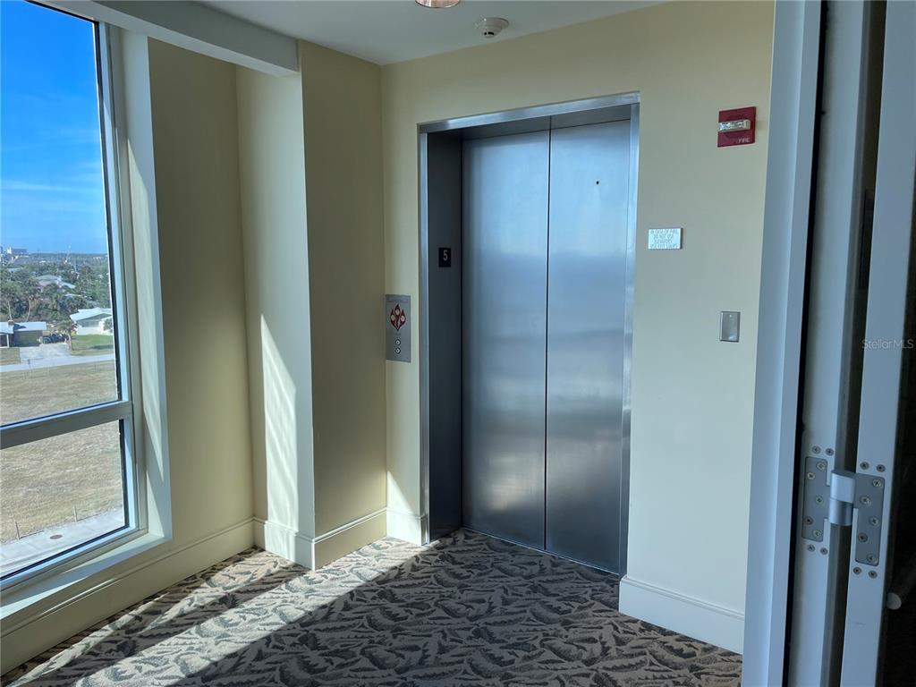 a view of a bathroom with a glass door and windows