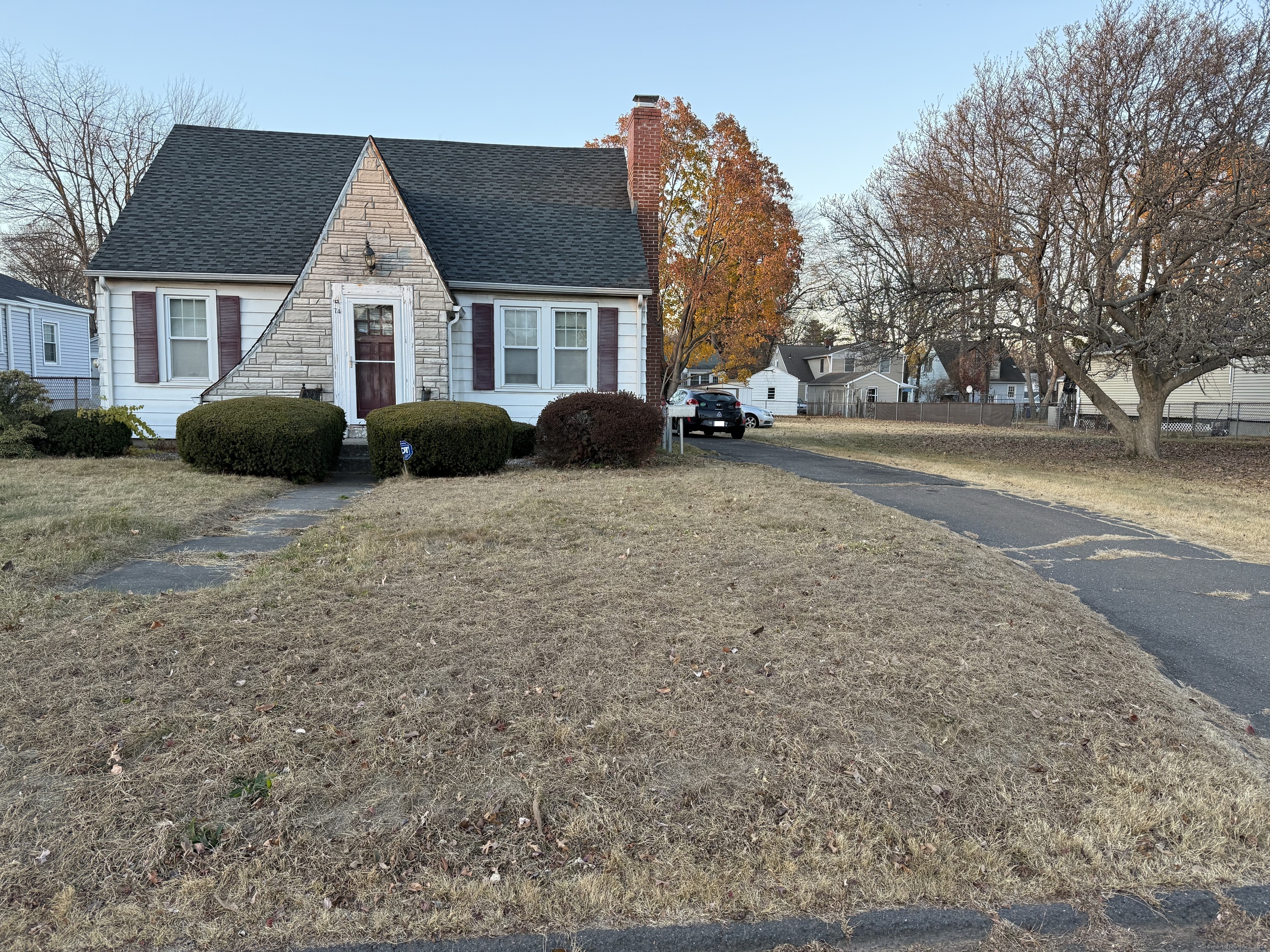 a view of a house with a yard covered in snow