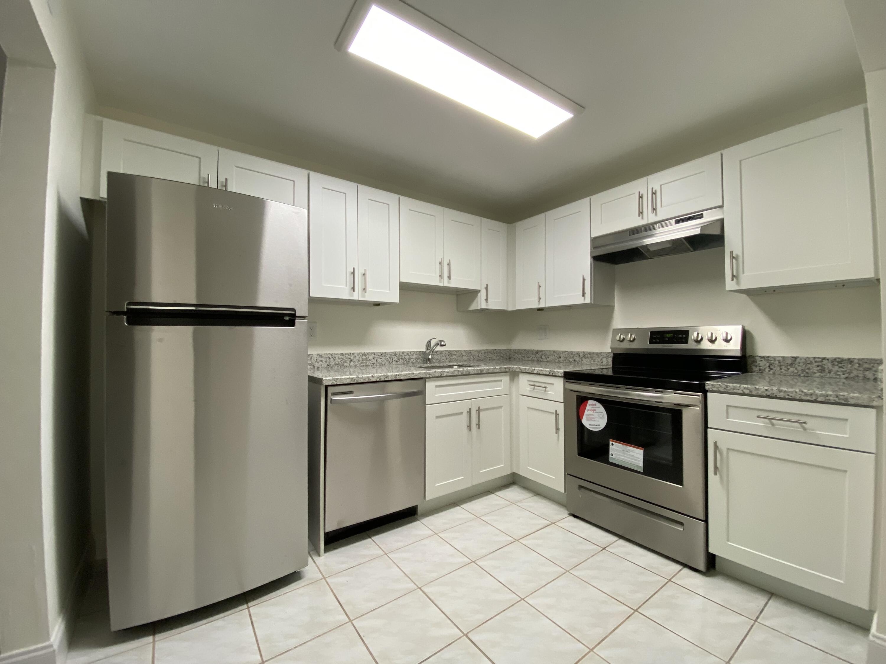 a kitchen with a refrigerator sink and stove