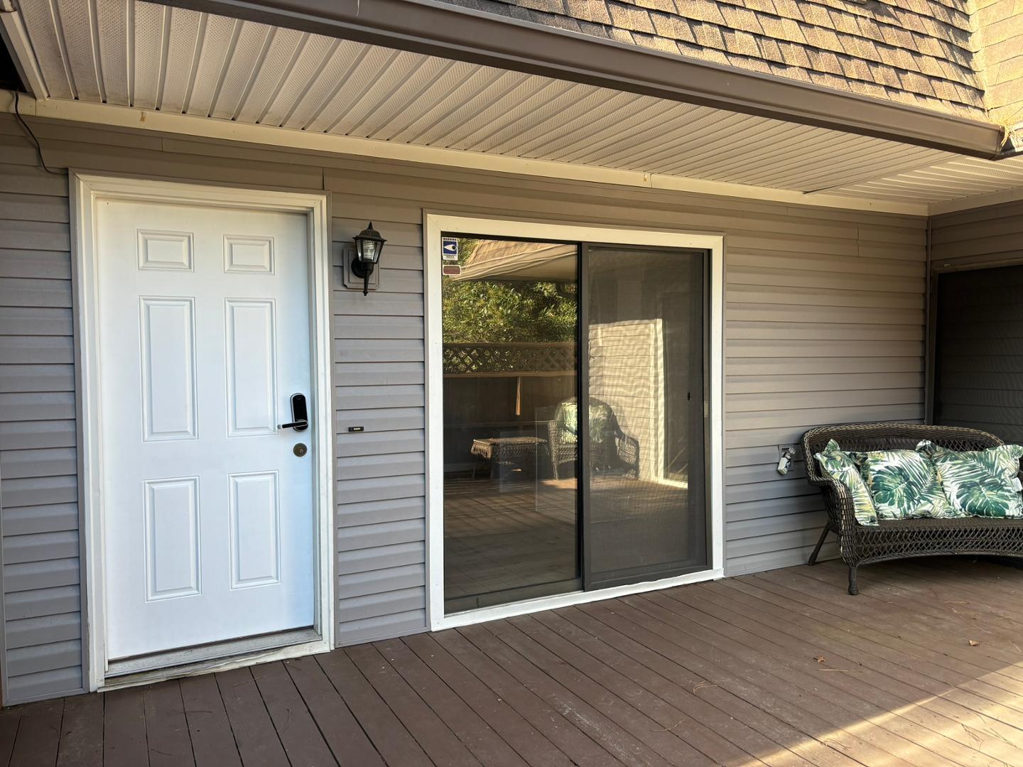 a view of a porch with wooden floor and a ceiling fan