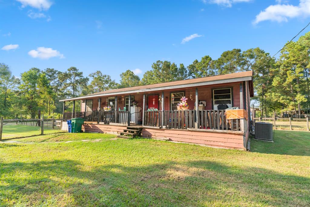 a view of a house with a yard patio and deck