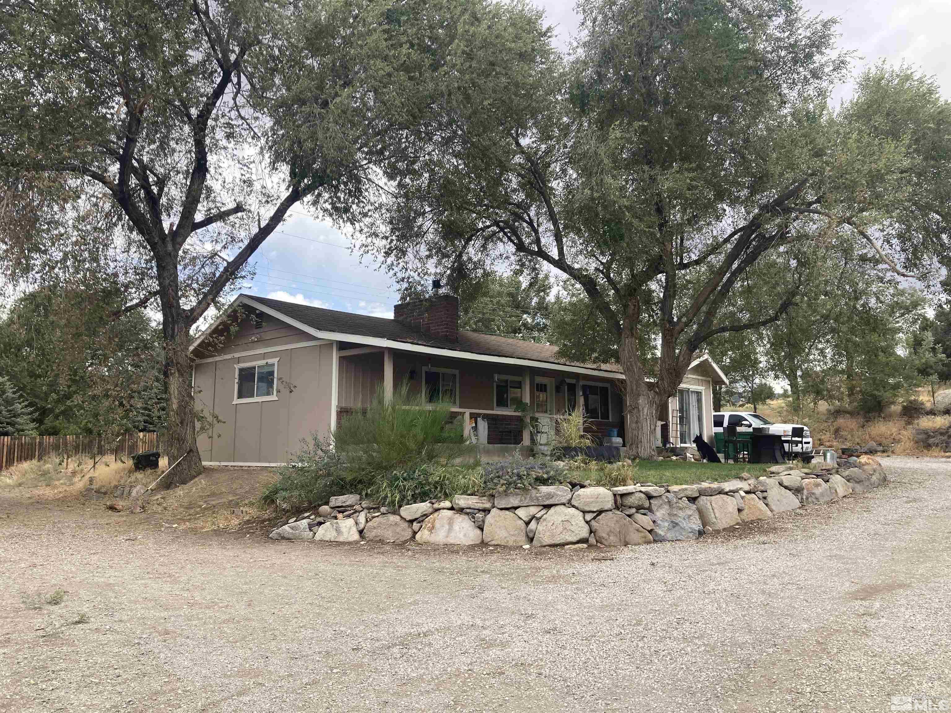 a view of a house with a yard and sitting area