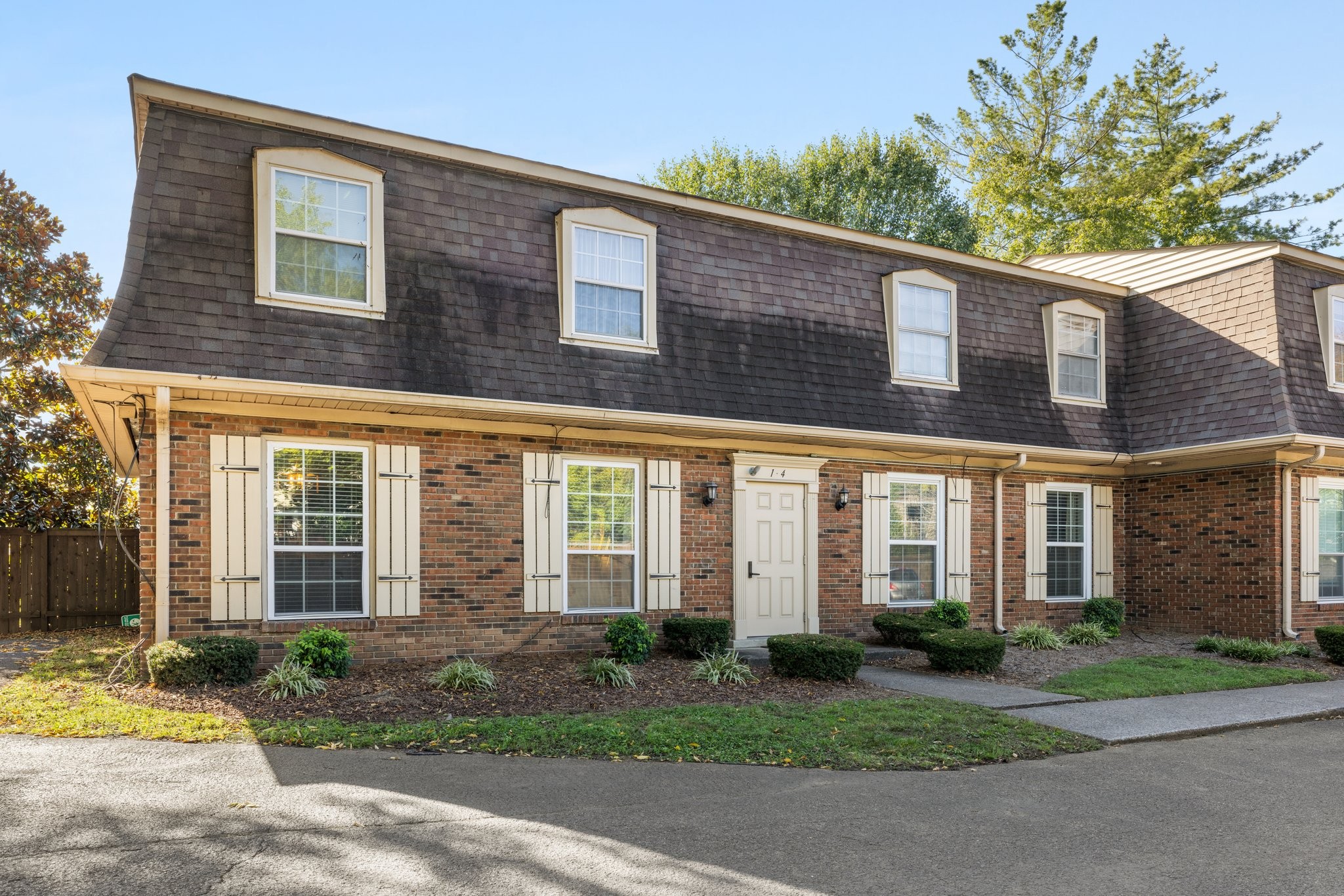 a view of a brick building next to a yard