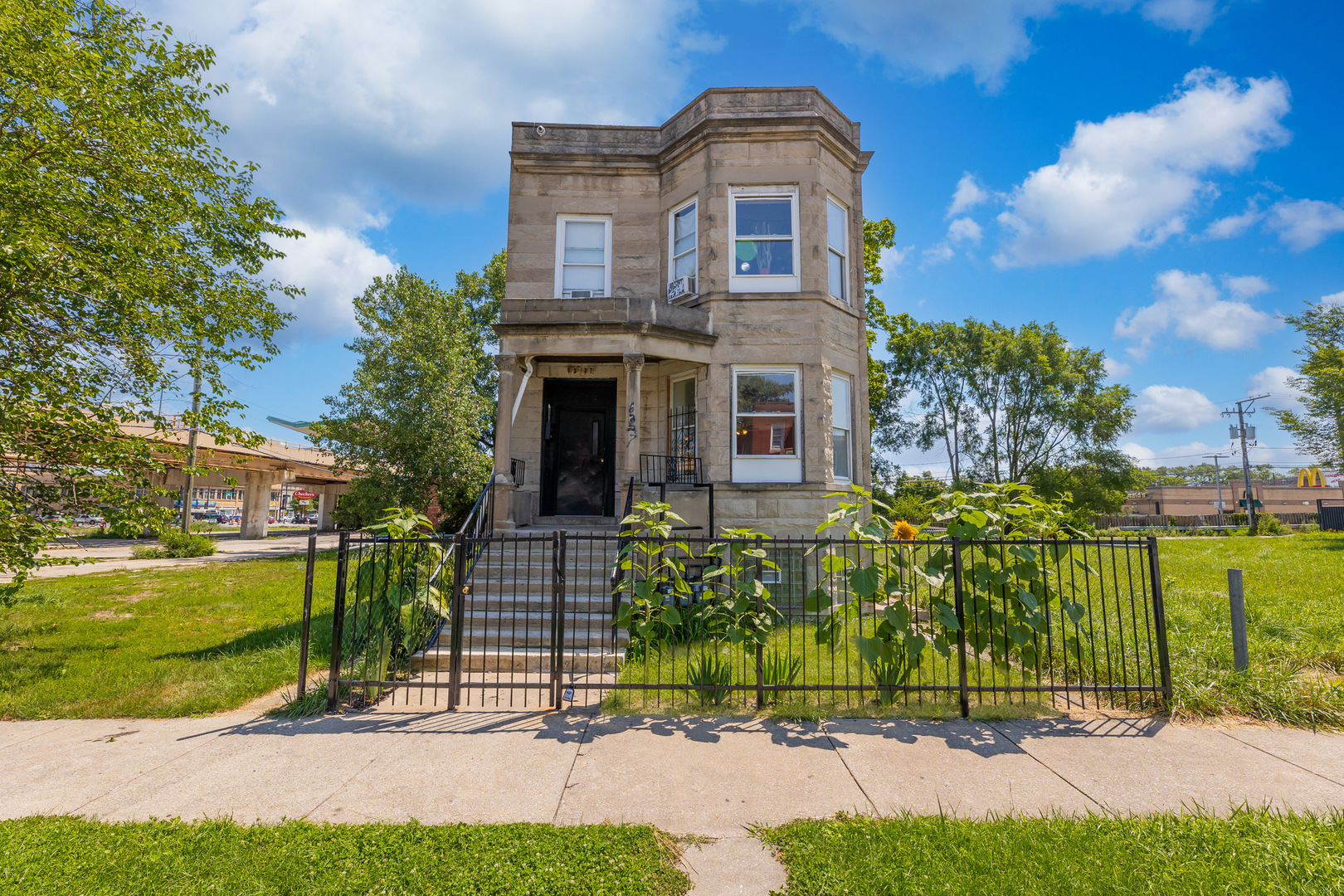 a front view of a house with a garden