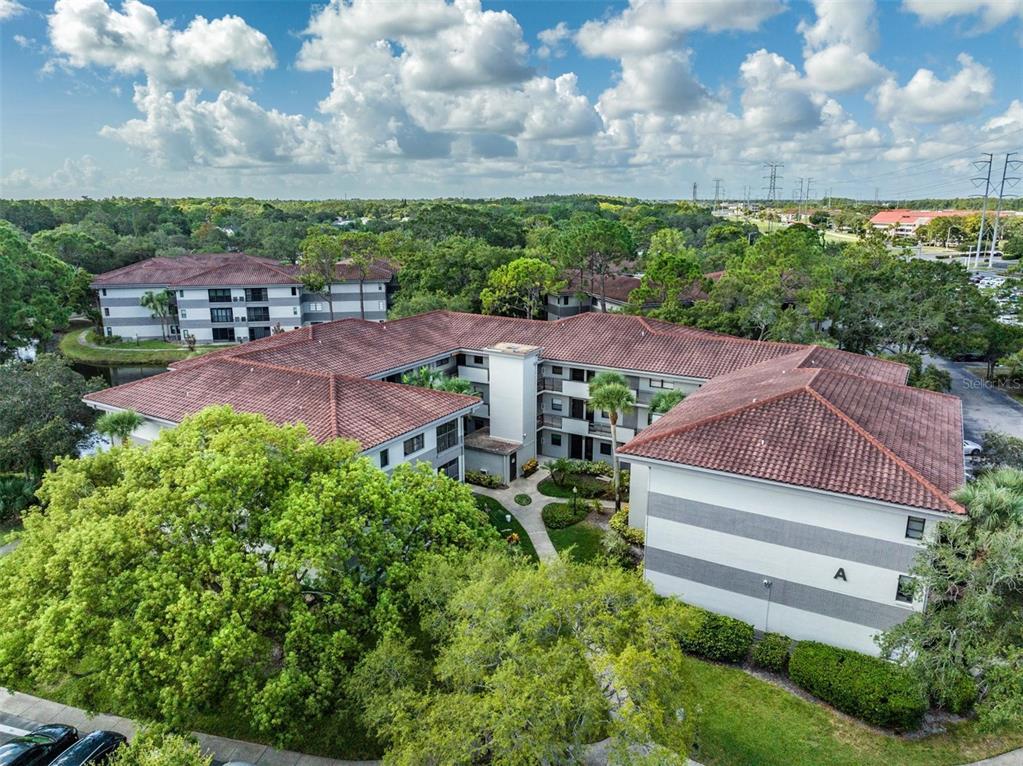 an aerial view of multiple houses with a yard