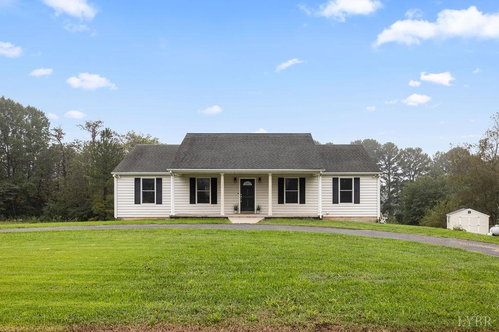 a front view of house with yard and green space