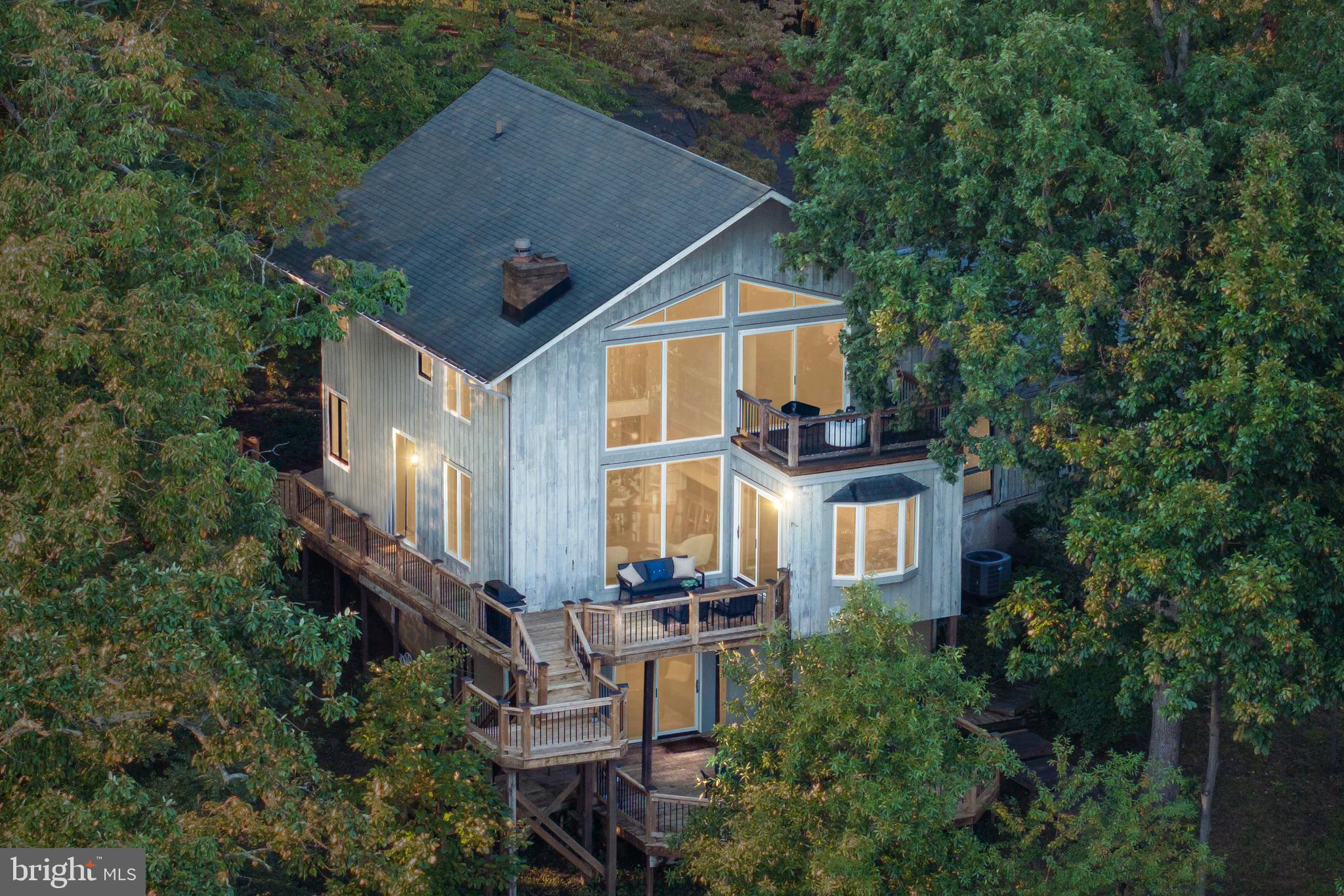 an aerial view of a house with a yard and balcony