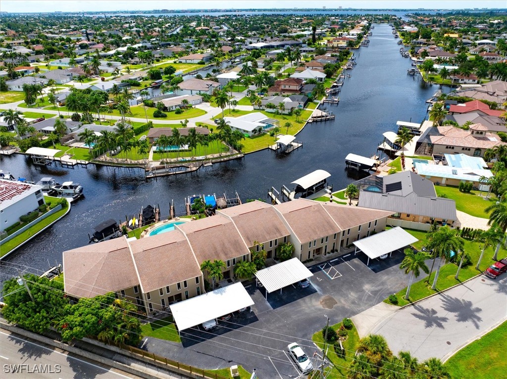 an aerial view of a house with garden space and lake view