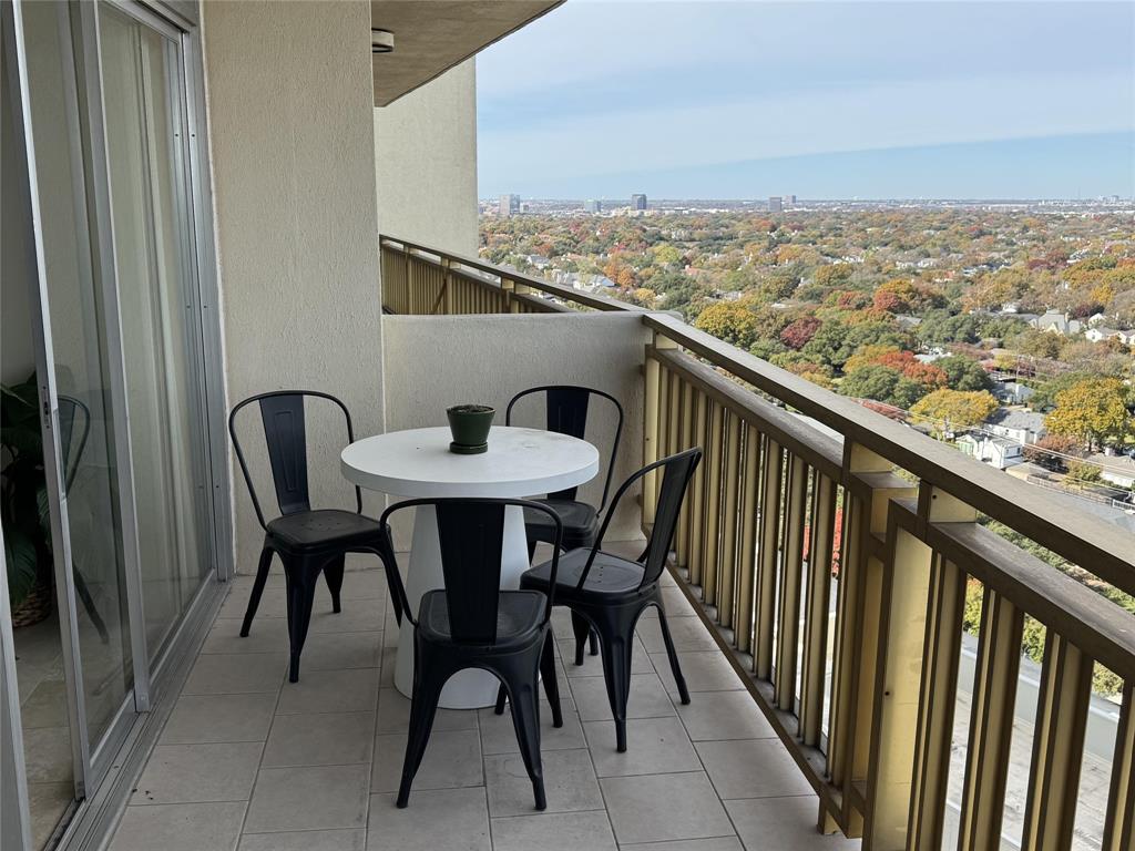 a view of a chairs and table in the balcony