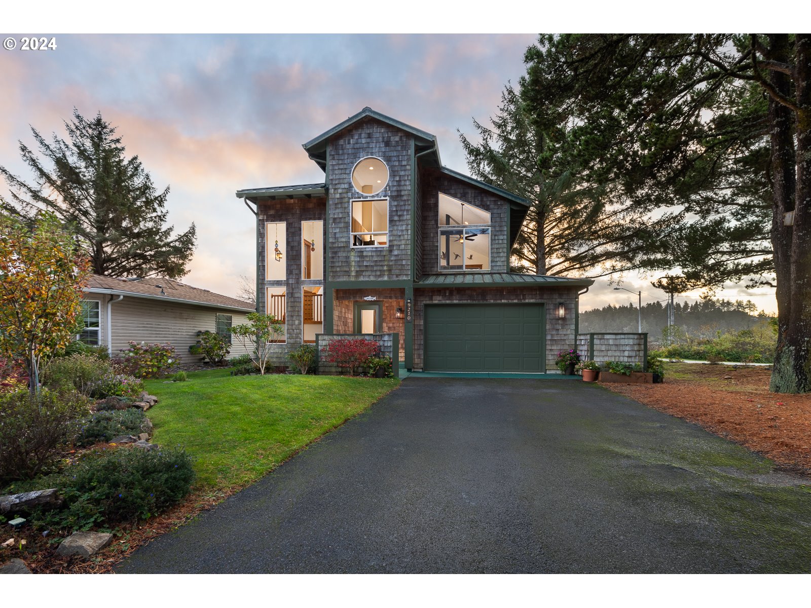 a front view of a house with a yard and garage