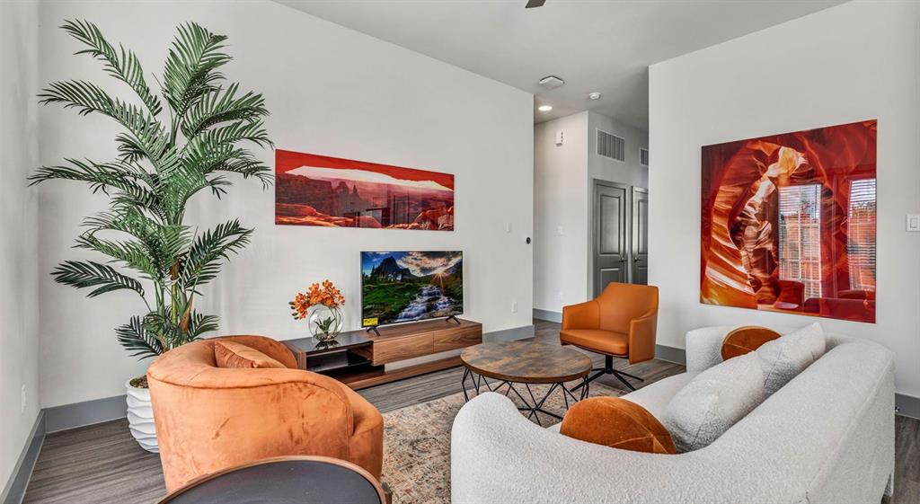 a living room with furniture and a potted plant