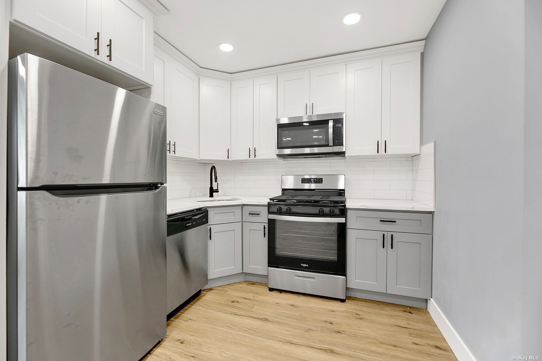 a kitchen with stainless steel appliances a refrigerator stove and microwave