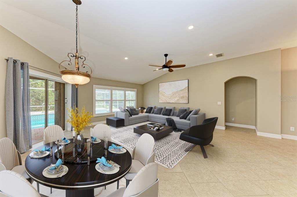 a living room with furniture a window and a chandelier