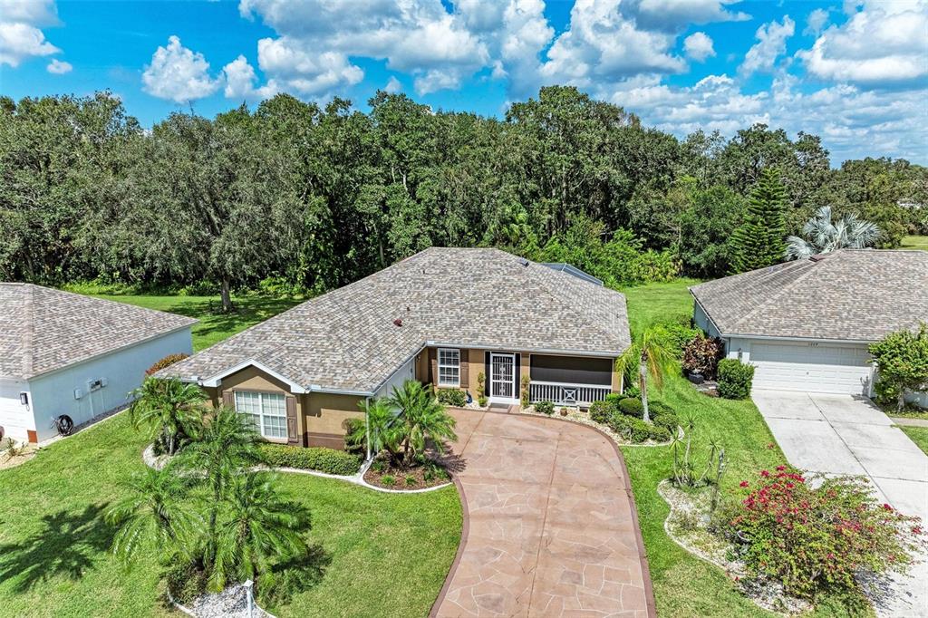 a aerial view of a house with plants and large trees