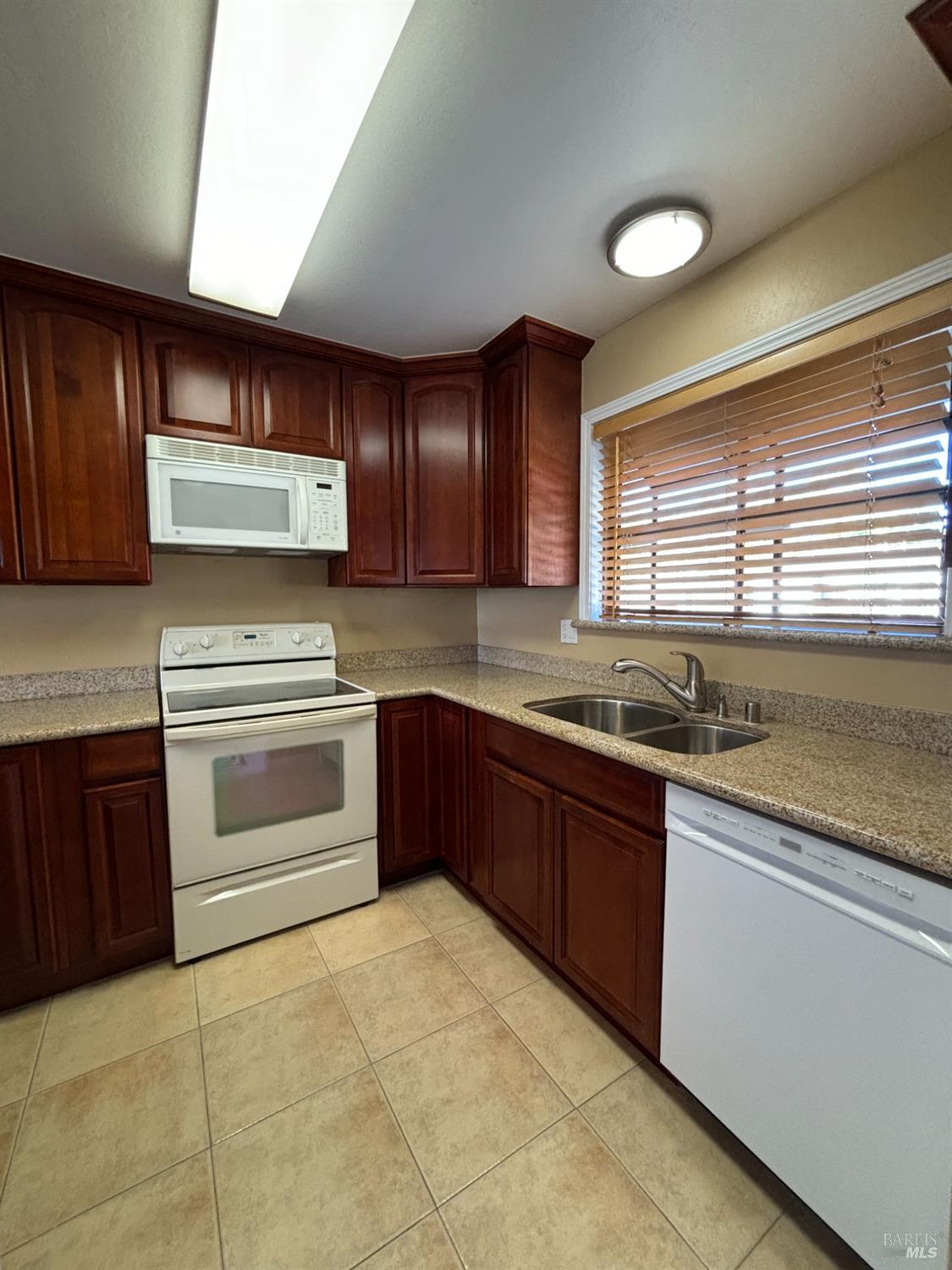 a kitchen with a sink stove and microwave