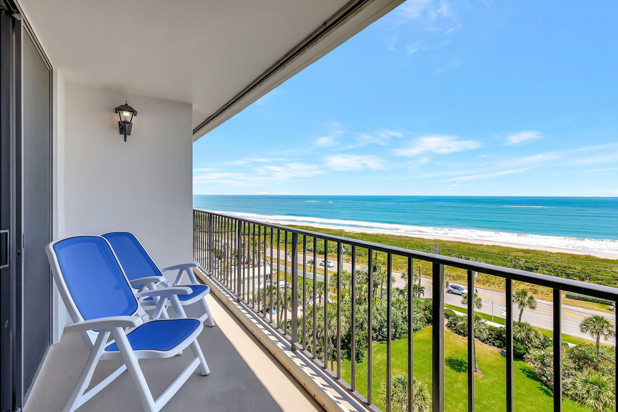 a balcony with table and chairs