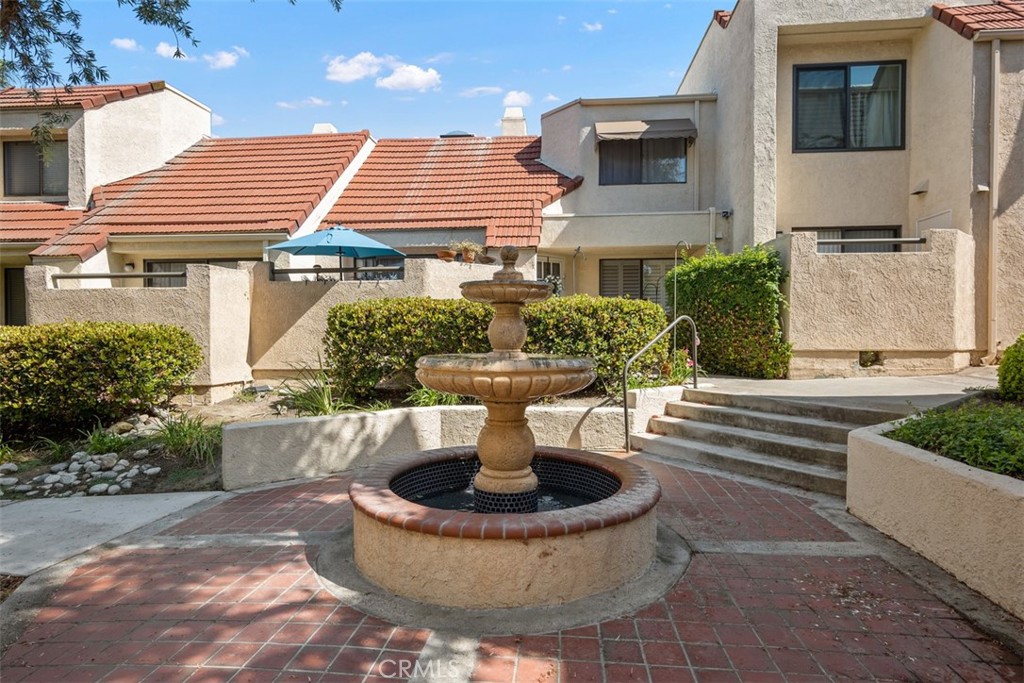 Serene location in the center of the Crystal Cay community with water fountain outside patio