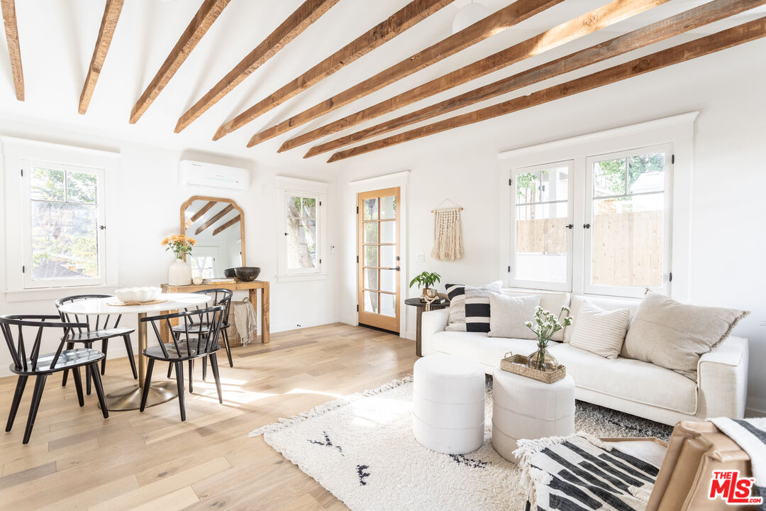 a living room with furniture a wooden floor and a chandelier