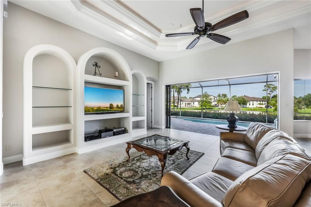 a living room with furniture and a floor to ceiling window