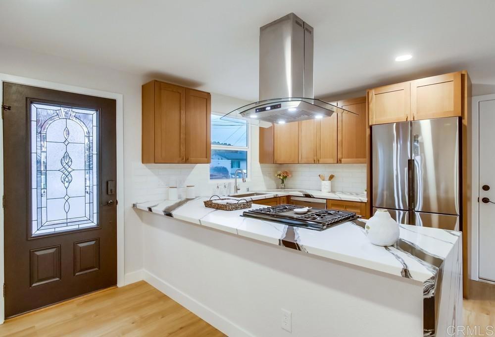 a kitchen with stainless steel appliances granite countertop a sink stove and refrigerator