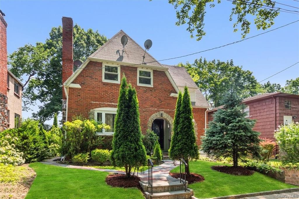 Tudor house featuring a front yard