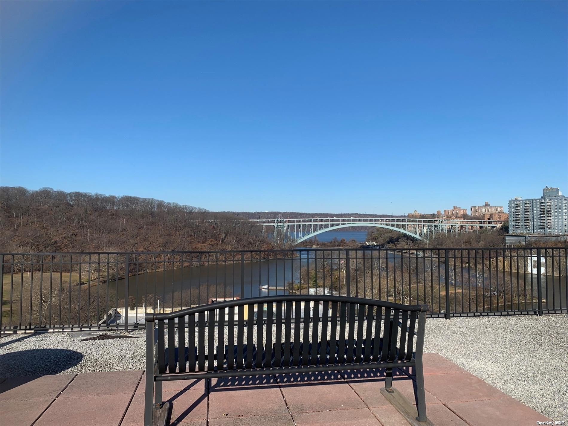 a view of roof deck with wooden fence and city view