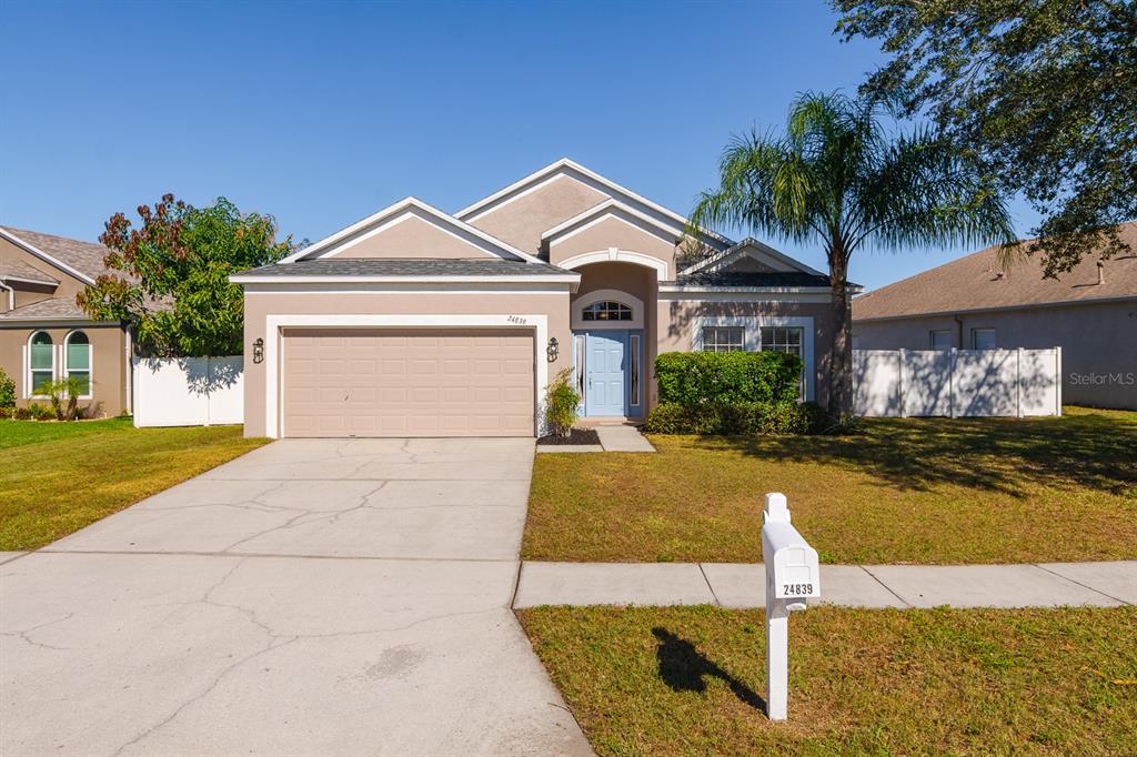 a front view of a house with a yard and garage