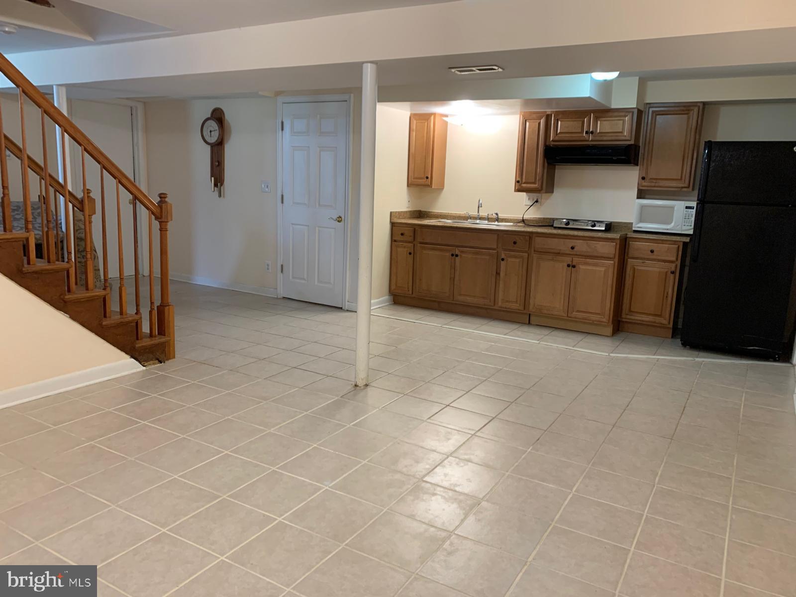 a view of a kitchen with a sink and a refrigerator