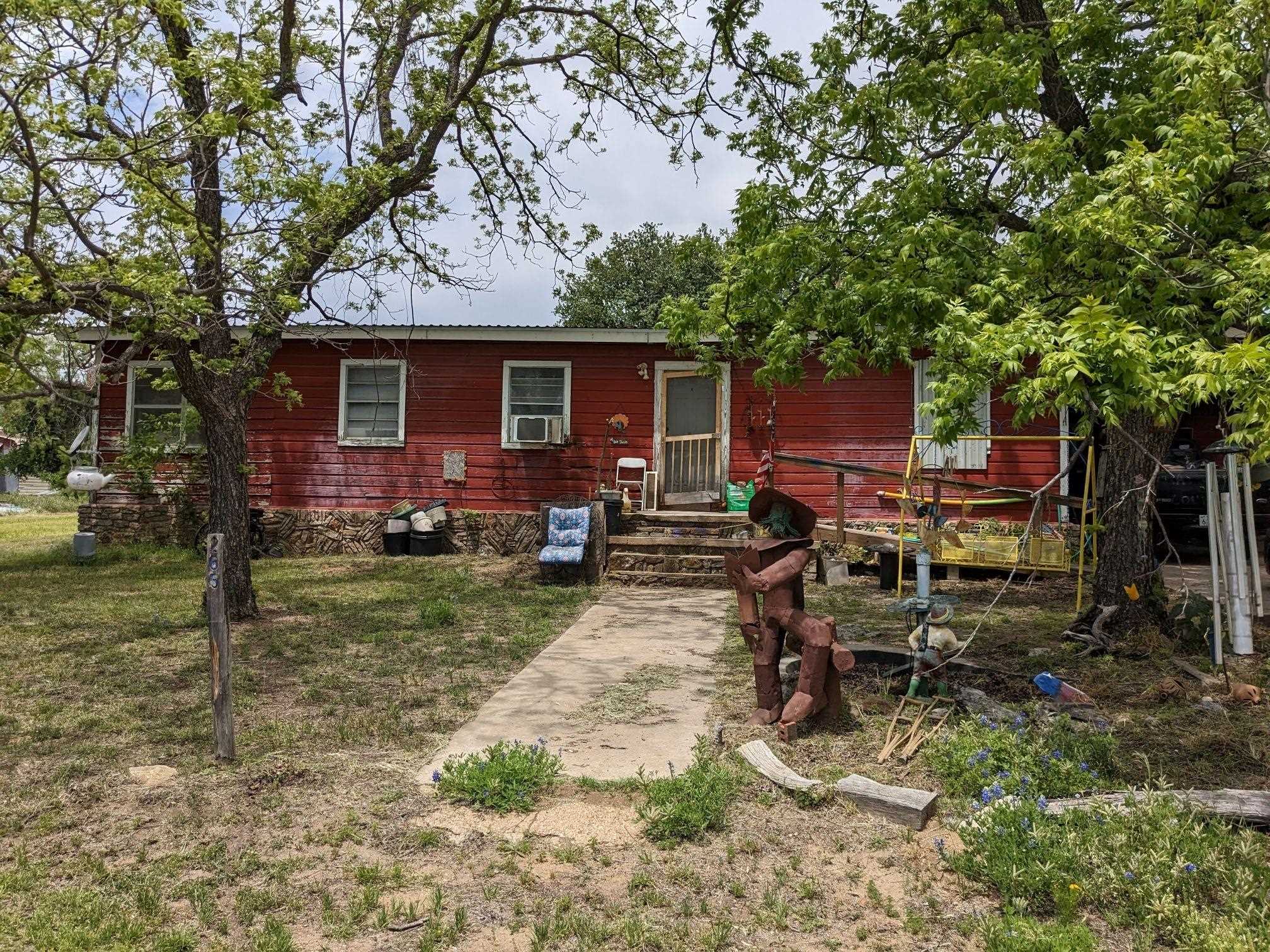 a view of backyard of house with seating space