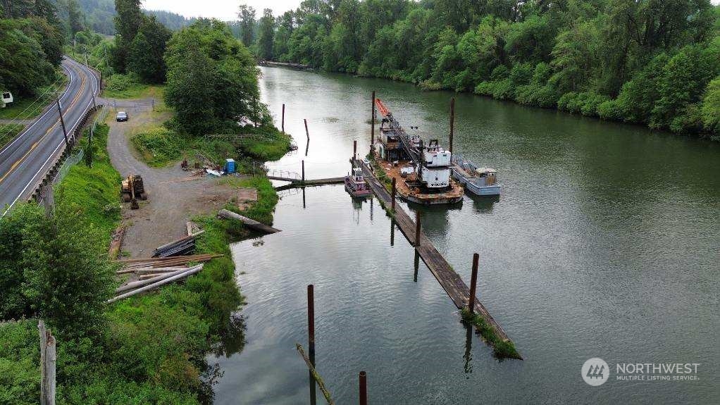 an aerial view of a house lake view and a yard