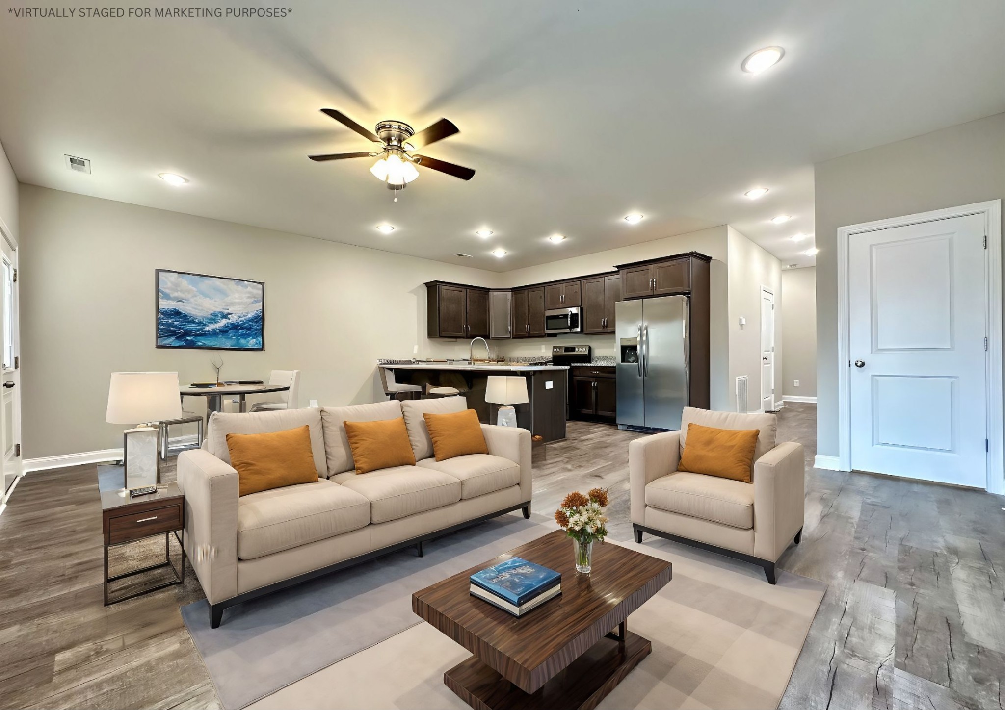 a living room with furniture and kitchen view