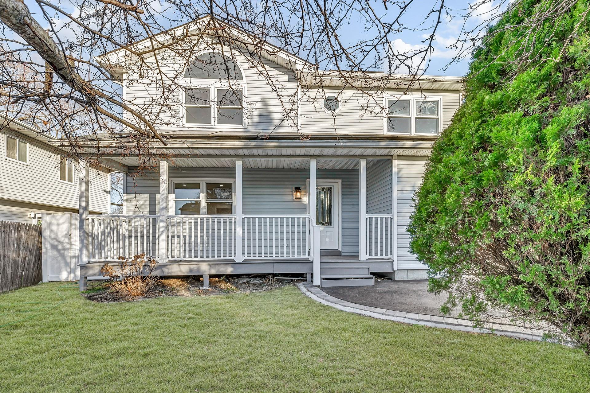 View of front of home with a front lawn and covered porch