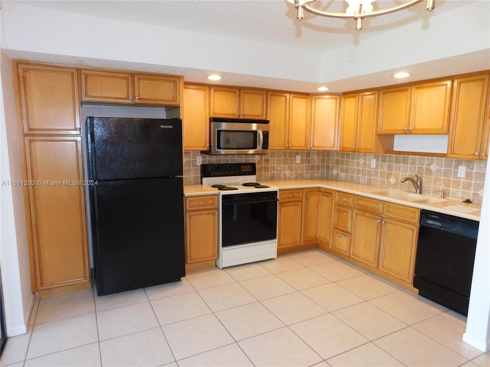 a kitchen with a refrigerator sink and microwave