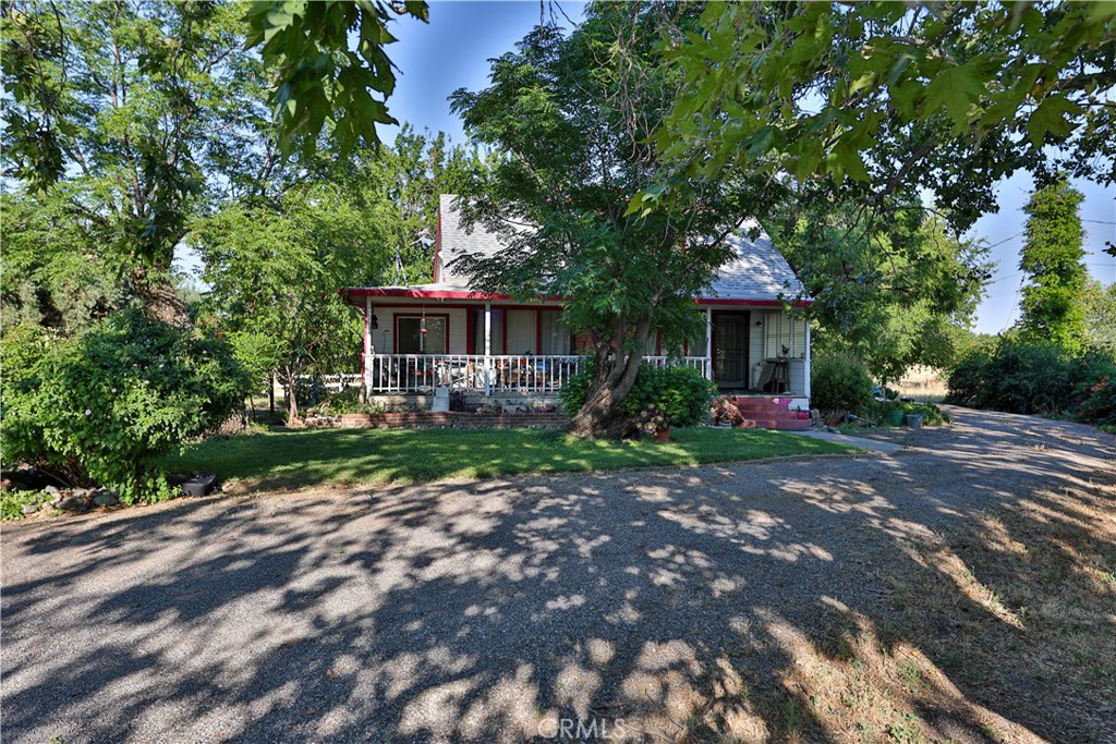 a front view of a house with yard and green space