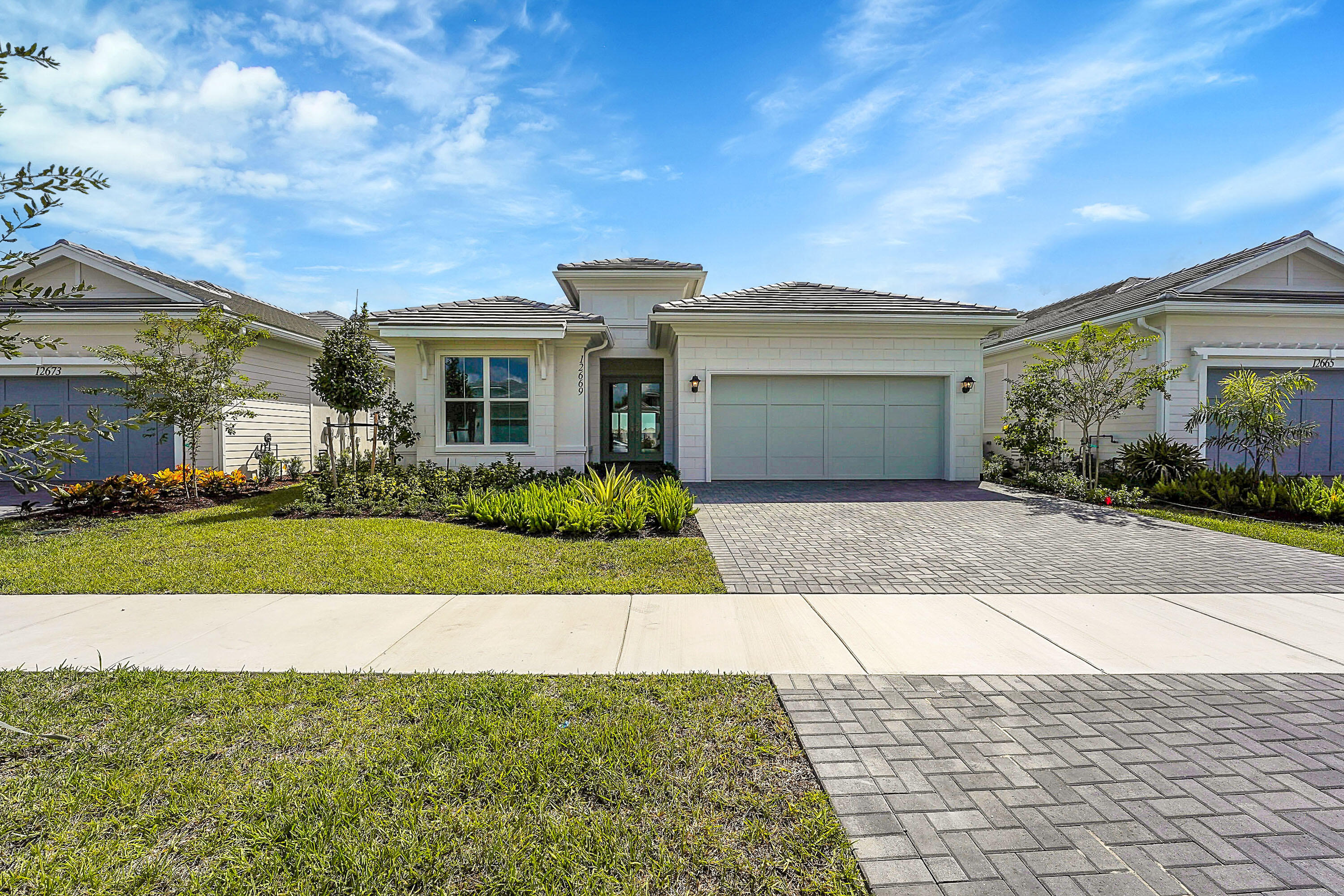 a front view of a house with a garden and yard