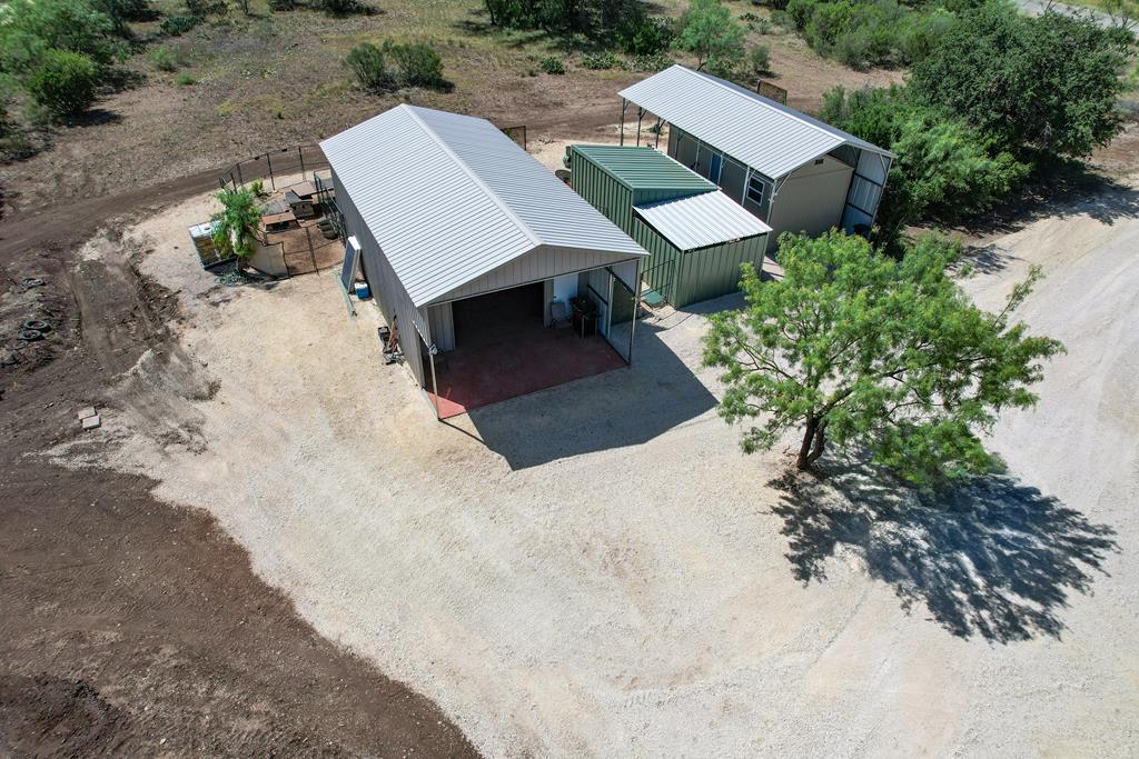 an aerial view of a house with a yard and sitting area